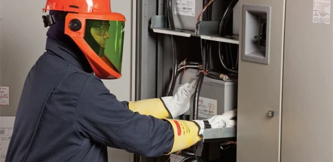 technician performing battery replacement in a cabinet