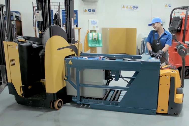 A battery being installed into a forklift.