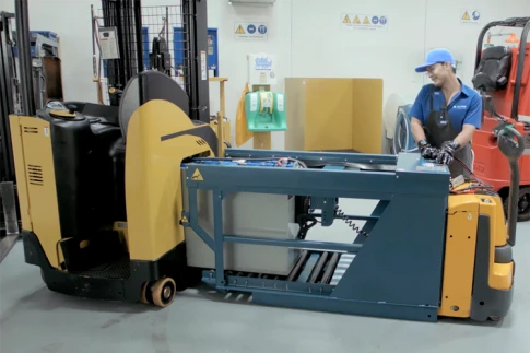 A battery being installed into a forklift.